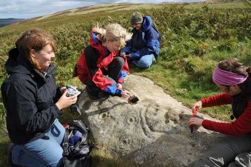 Figure 8. Participants engaging with rock art, Lordenshaw site visit (Rothbury, Workshop 3)